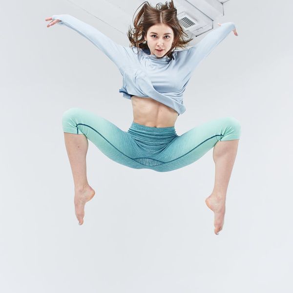 Person in a dynamic cardio pose showing flexibility and strength.